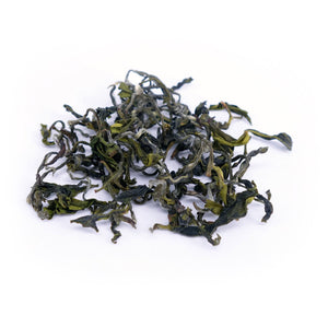 Biluochun Green loose tea leaves on white surface