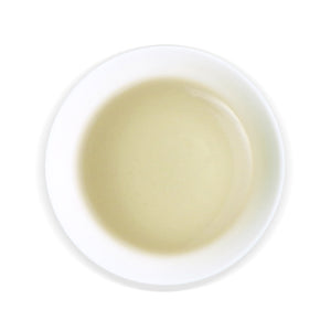 overhead view of white cup with Dongding Oolong tea inside