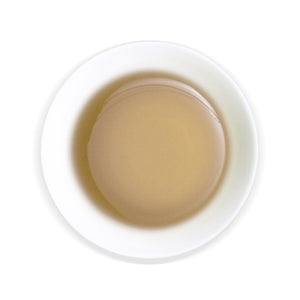 overhead view of white cup with Honey GABA Oolong tea inside