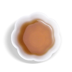 overhead view of white cup with Taiwan Native Mountain Tea tea inside