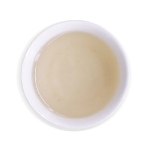 overhead view of white cup with Pinglin White Tea inside