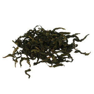 Wenshan Baozhong whole tea leaves on white surface